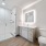 Modern bathroom with glass shower, sleek fixtures, and elegant tile work at The Birney Apartments