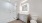Modern bathroom with glass shower, sleek fixtures, and elegant tile work at The Birney Apartments