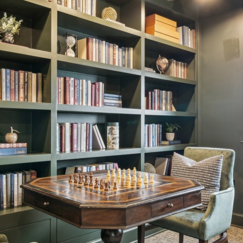 Cozy library with bookshelves and comfortable seating inside The Birney Apartments clubhouse Cozy library with bookshelves and comfortable seating inside The Birney Apartments clubhouse